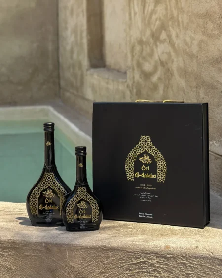 Oro Al Andalus luxury gift case with two arabesca bottles of Picual extra virgin olive oil, limited edition, displayed on a stone surface with an ornate gold design box