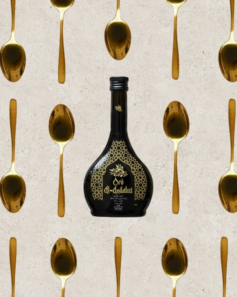 Oro Al Andalus Arabesca Extra Virgin Olive Oil 250ml bottle centred on a stone background surrounded by a pattern of gold tasting spoons